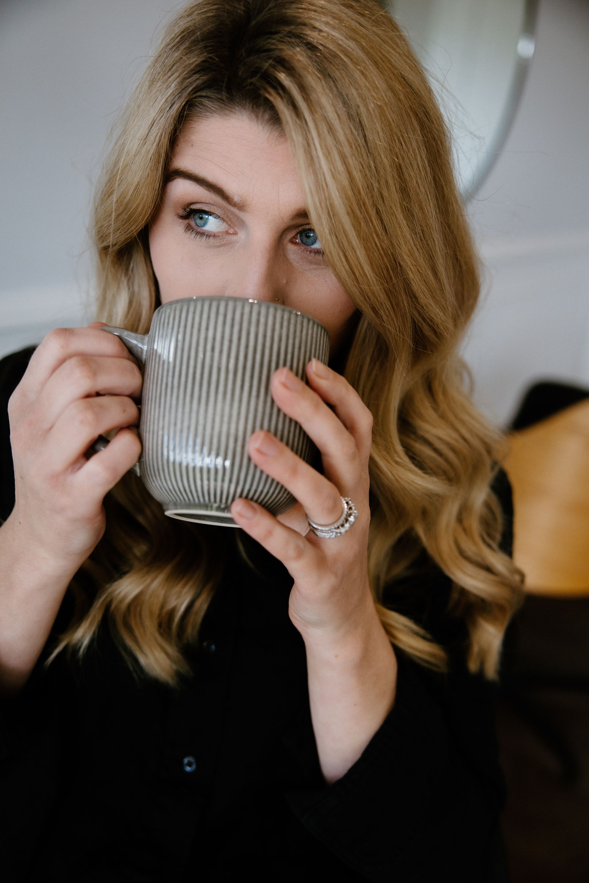 Maree holding a warm drink before a Japanese Head Spa consultation